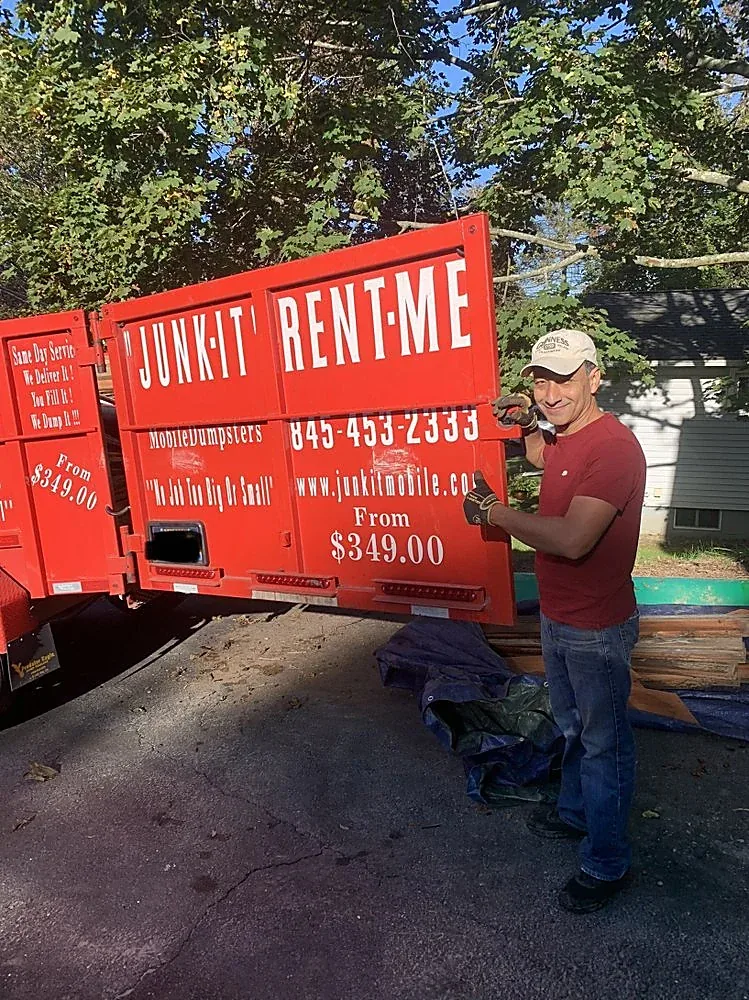 A row of Junk It Mobile Dumpsters rubber-tired units ready for delivery